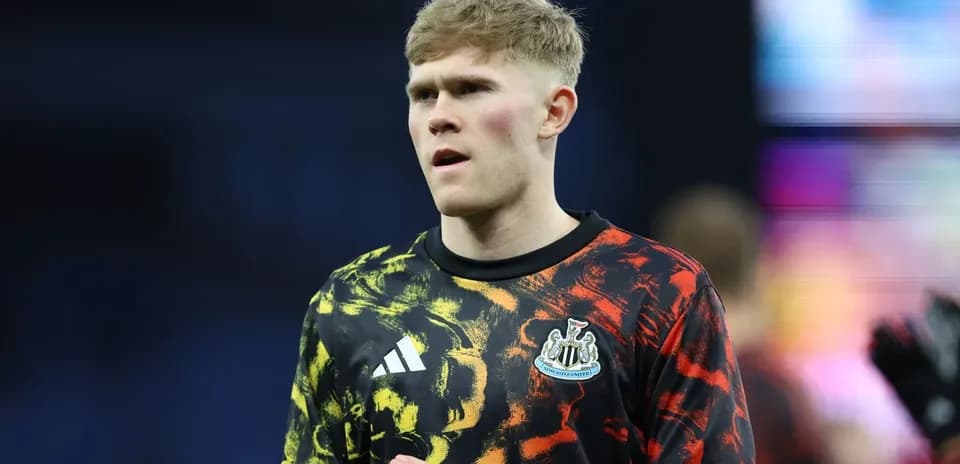 Player in Newcastle United warm-up jersey on pitch