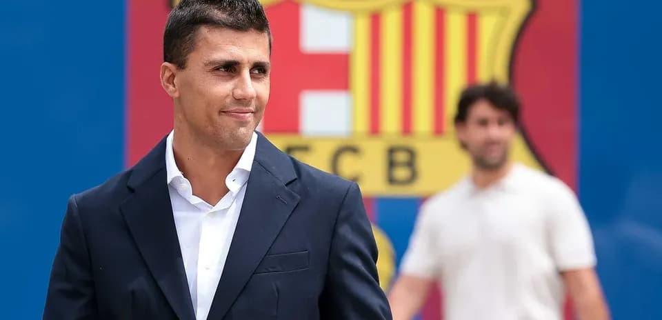 Man in suit with FC Barcelona logo background