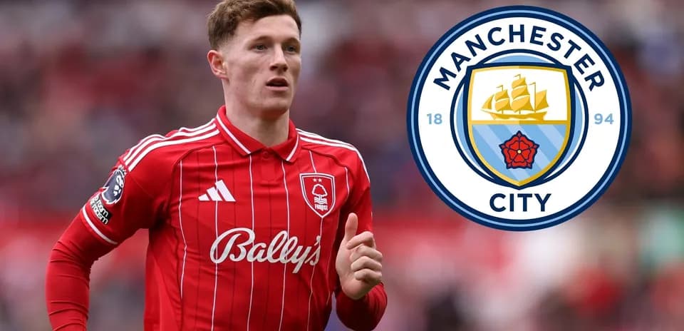 Player in red kit with Manchester City logo backdrop