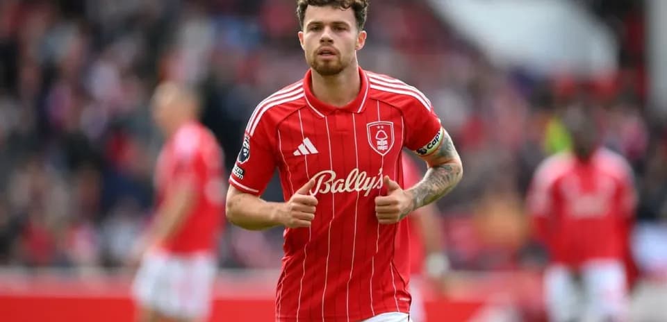 Player in red jersey jogging on the field