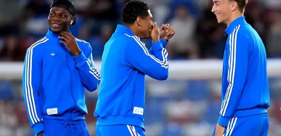 Three players chatting in blue training outfits