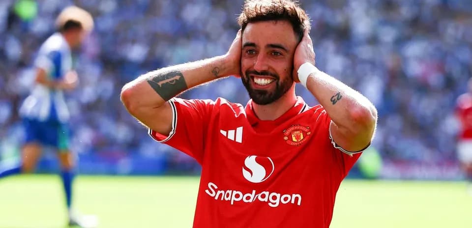 Player celebrating in Manchester United jersey on pitch