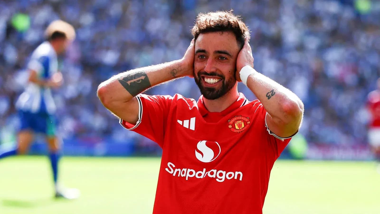 Player celebrating in Manchester United jersey on pitch