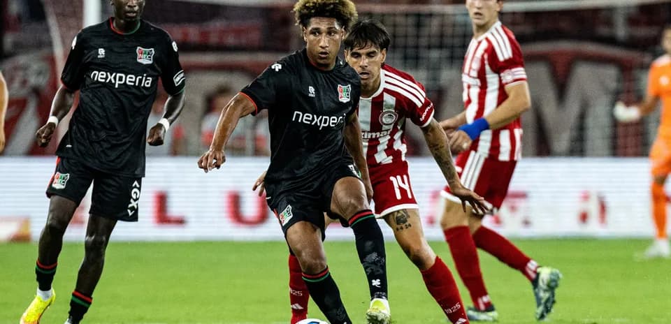 NEC Nijmegen player dribbling past Olympiakos opponent