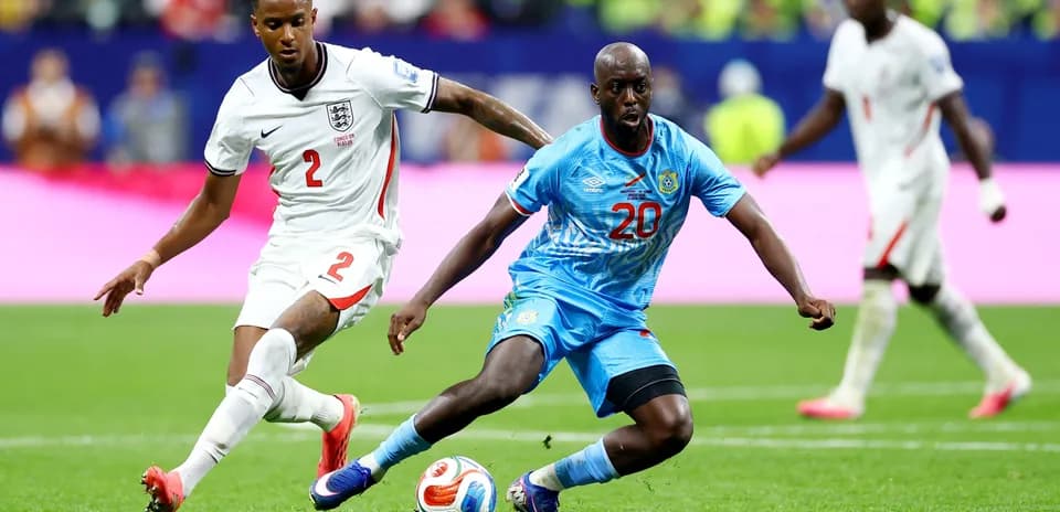 England player tackling Congo DR player during match