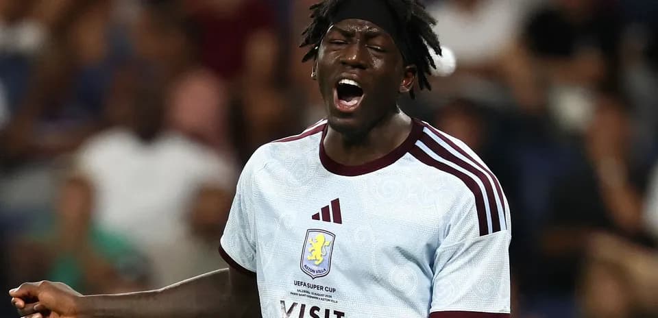 Player shouting during a match wearing Aston Villa jersey