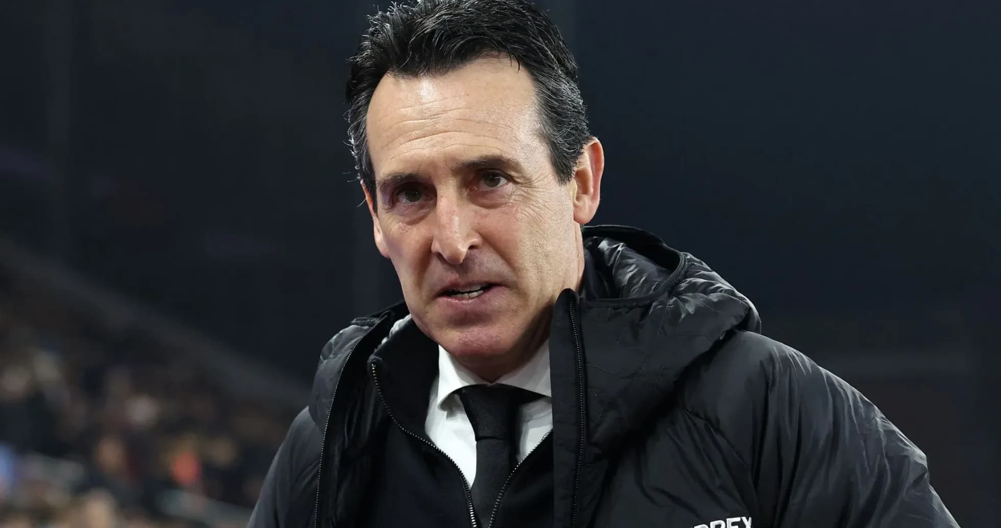 Coach wearing a black jacket during a match