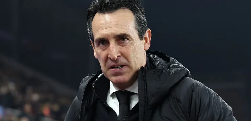 Coach wearing a black jacket during a match