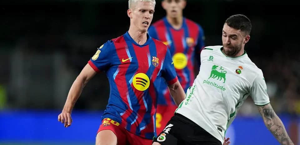 Barcelona player challenging Racing Santander opponent