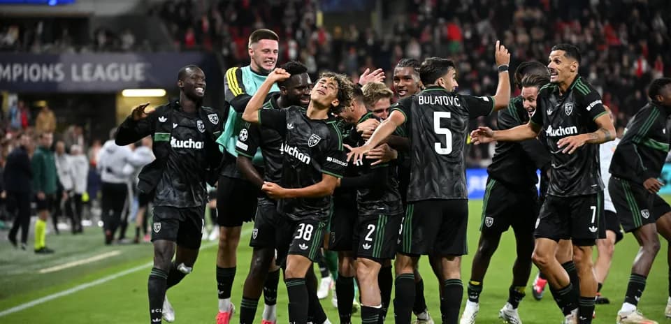 Players celebrating after scoring a goal in Champions League