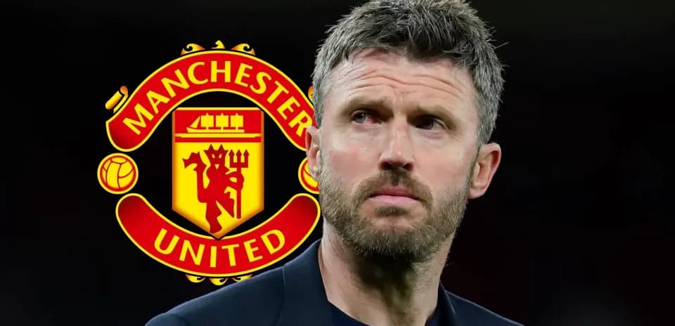 Man standing in front of Manchester United logo