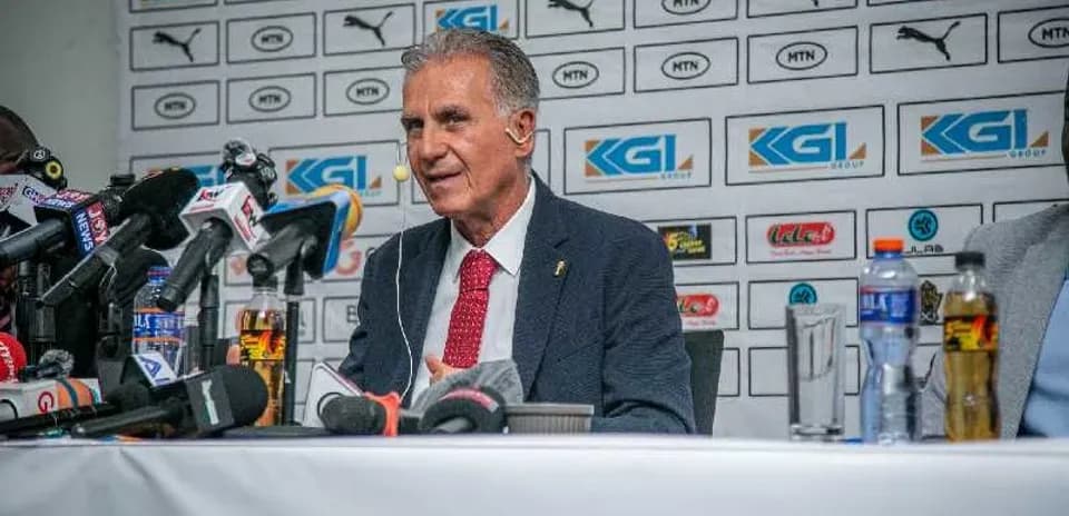 Coach speaking at press conference with media