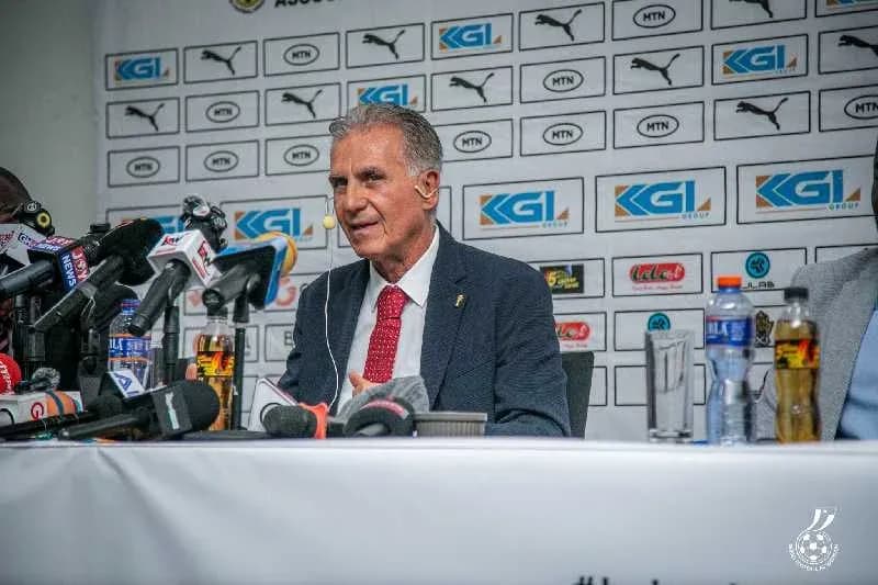 Coach speaking at press conference with media