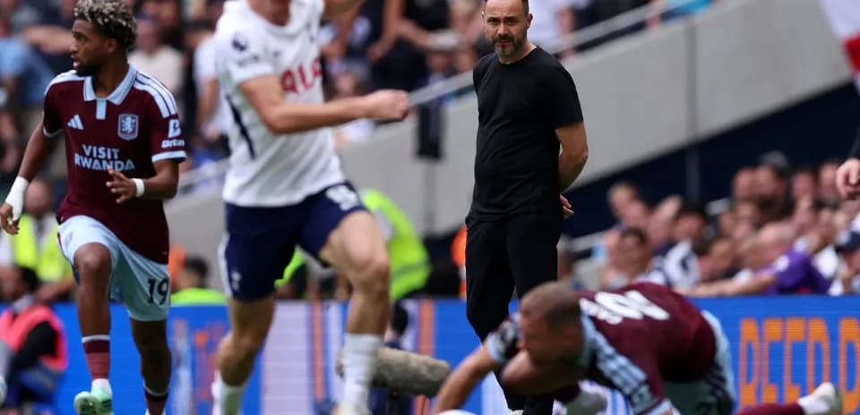 Aston Villa player running past Tottenham manager during match