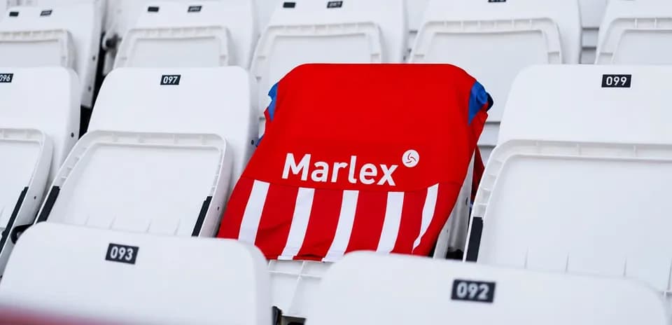 Red and white jersey placed on stadium seat
