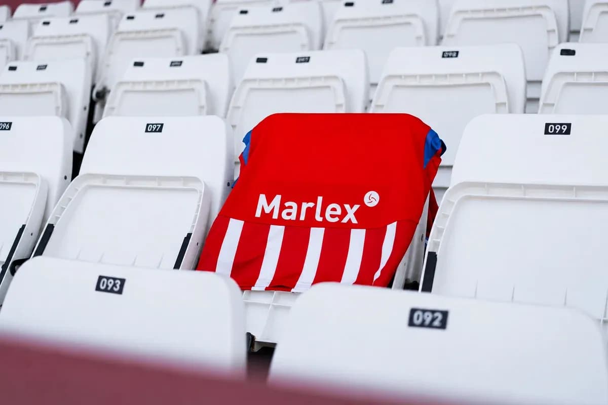 Red and white jersey placed on stadium seat