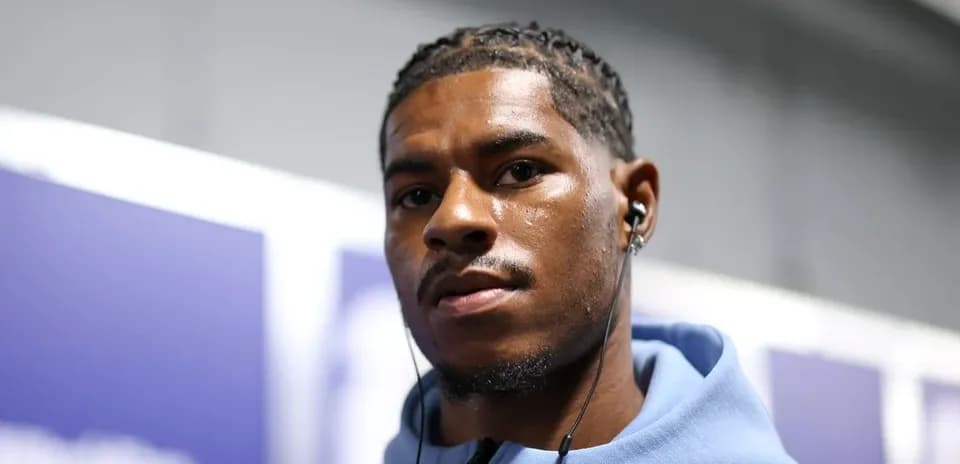 Athlete wearing headphones, looking at camera