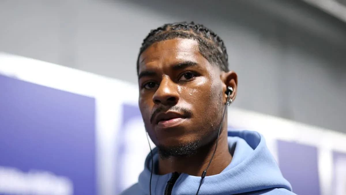 Athlete wearing headphones, looking at camera