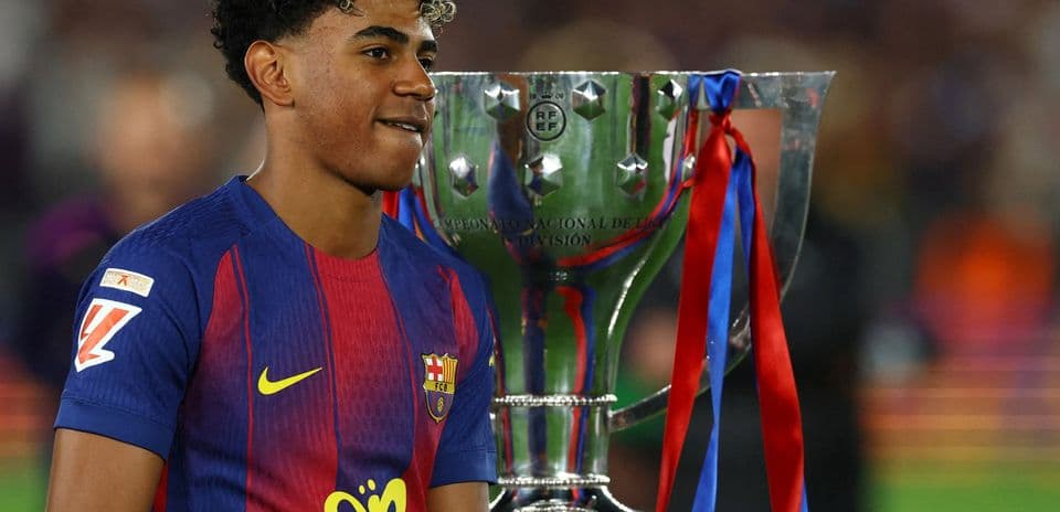 Player celebrating with trophy after winning championship