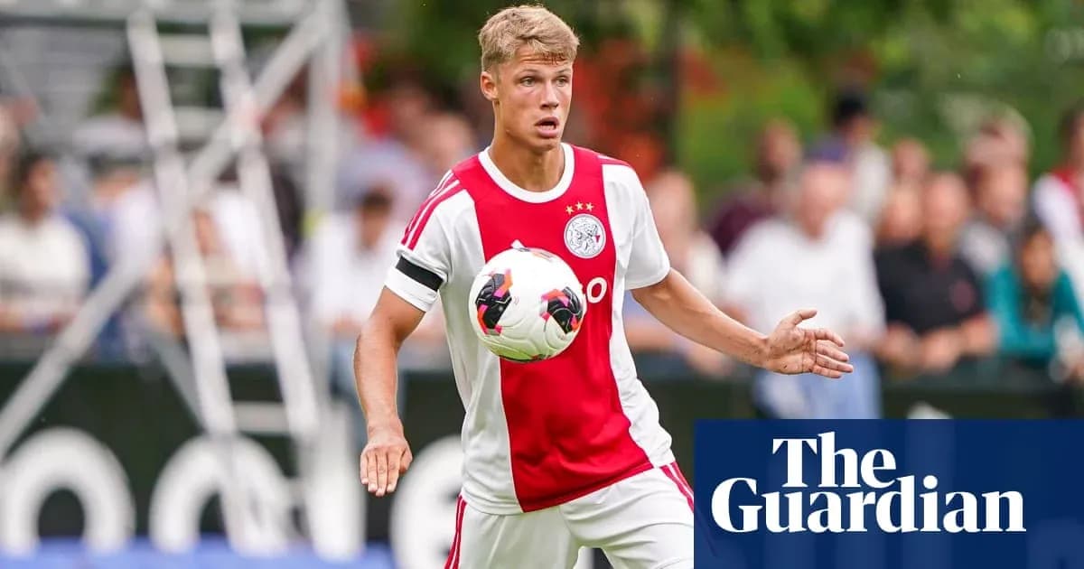 Player in Ajax kit controlling the ball during training