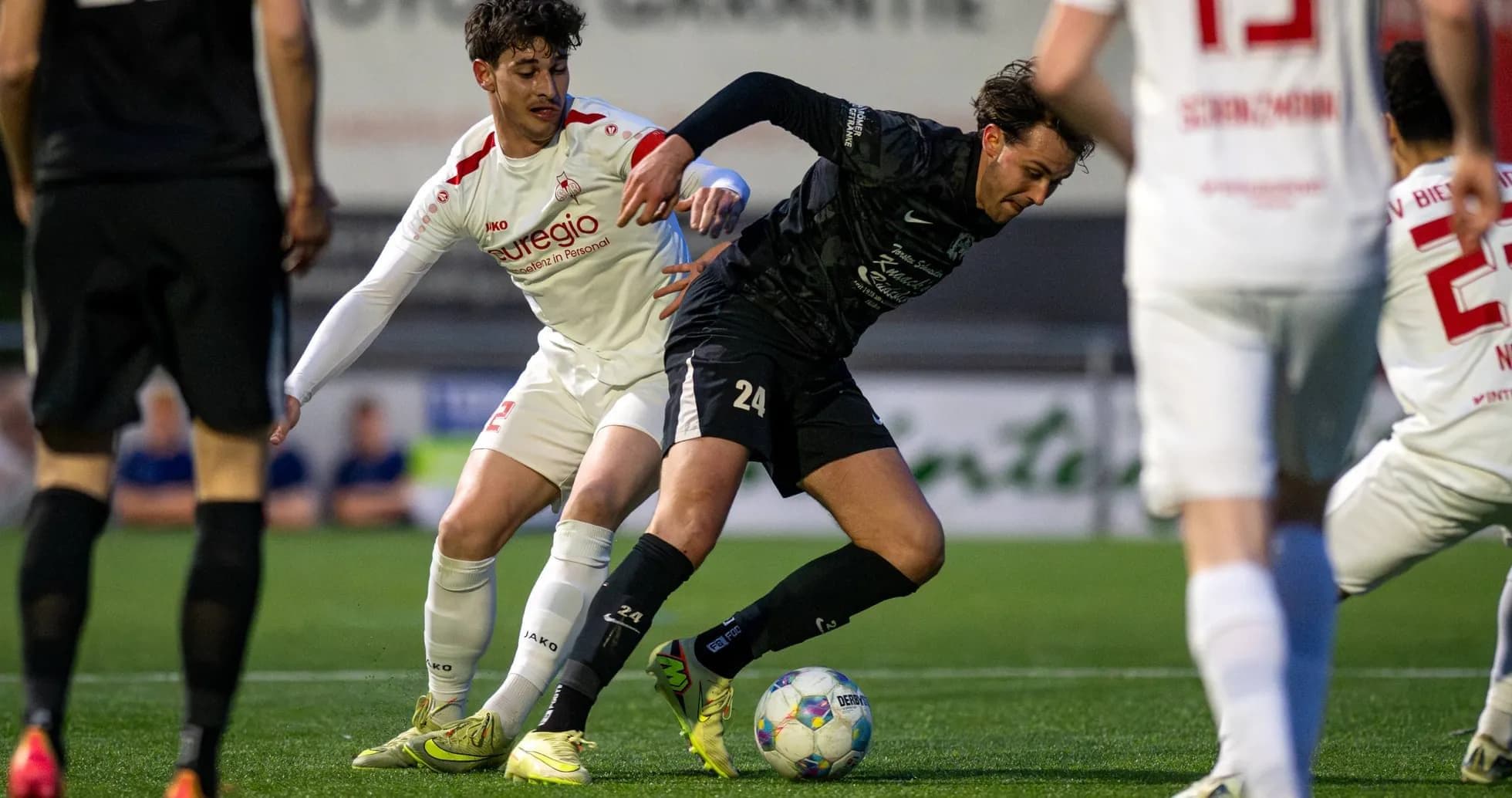 Two players battling for the ball in football match