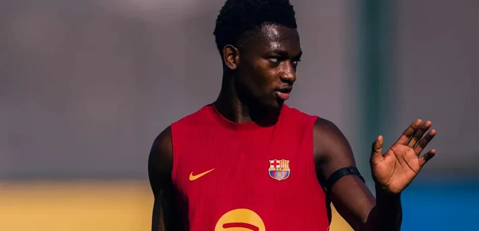 Player in training jersey gesturing on the field