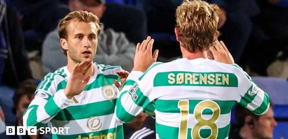 Celtic players exchanging a high five on pitch