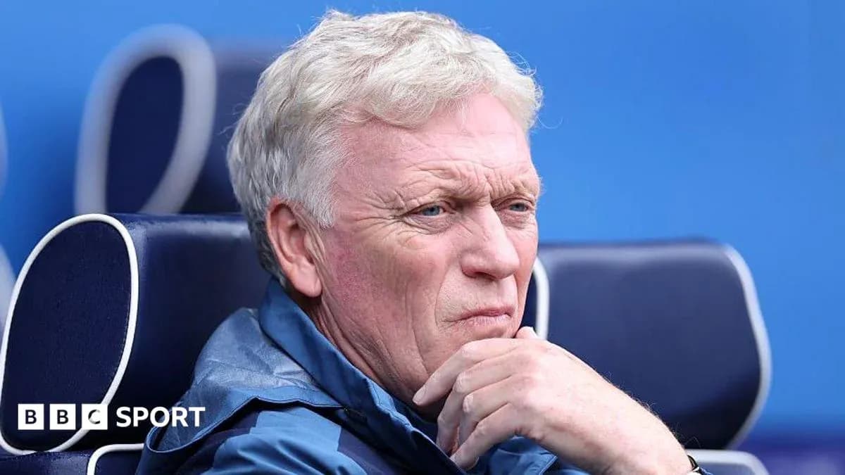 Coach seated on bench during a match
