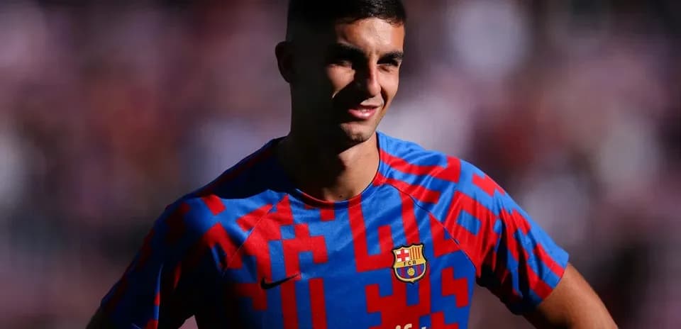 Player posing in Barcelona jersey with Spotify logo