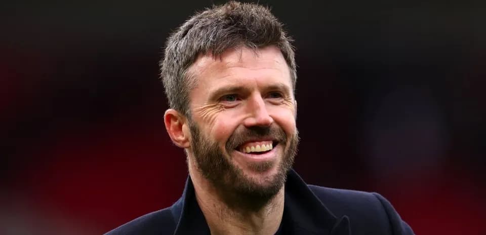 Man smiling in a dark coat outdoors