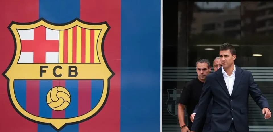 Player exiting building near FC Barcelona logo