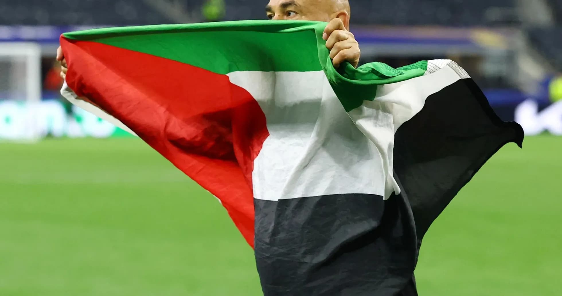 Person holding a flag on the field
