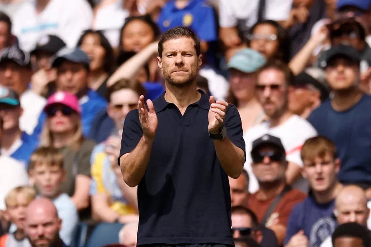 Coach applauding during a match with crowd behind