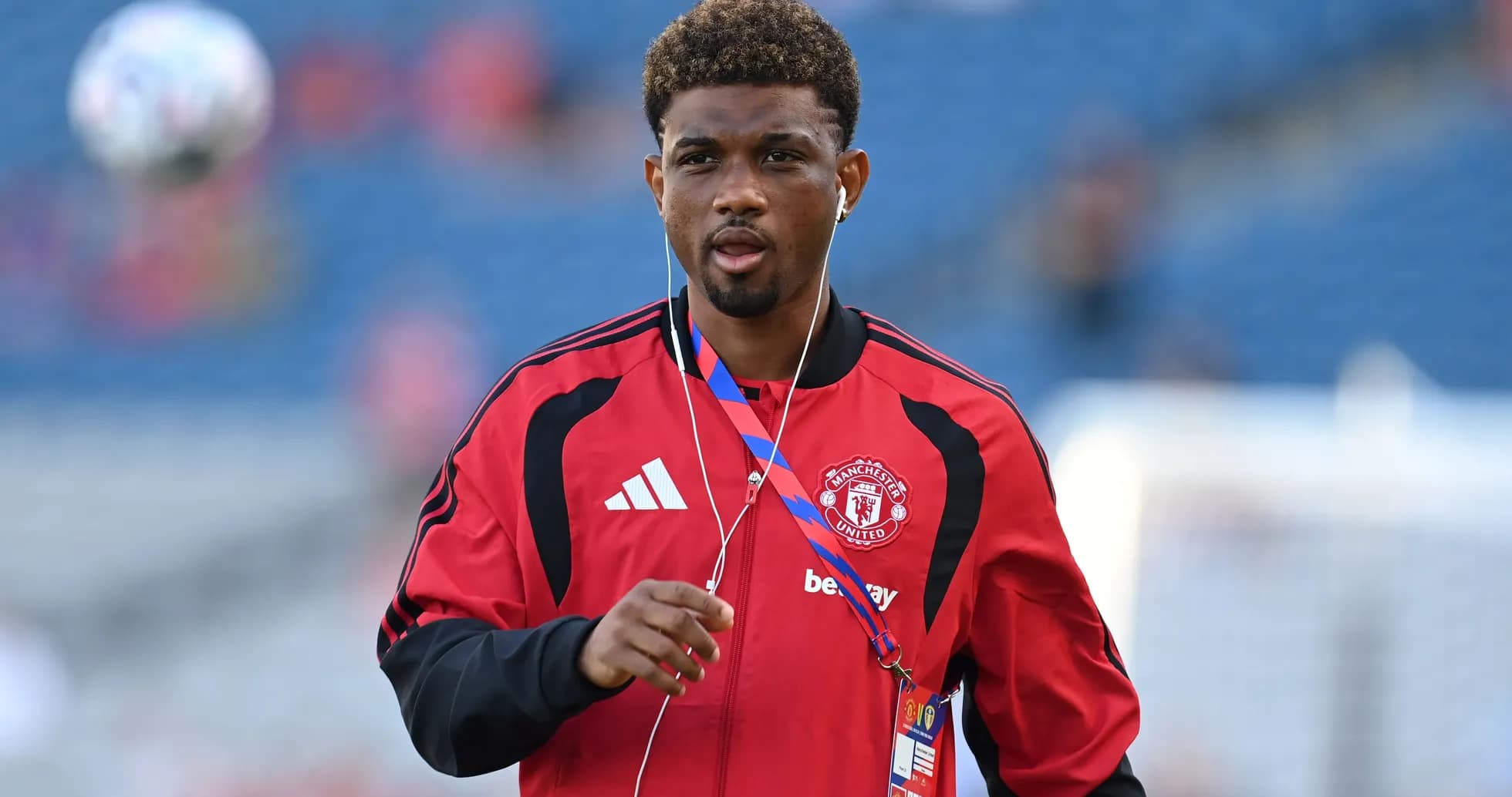 Player in Manchester United tracksuit warming up