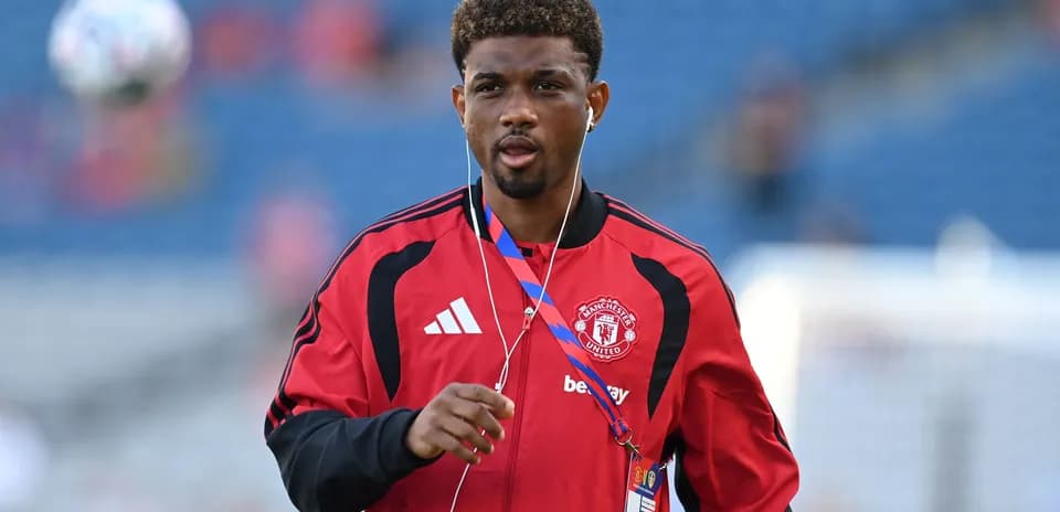 Player in Manchester United tracksuit warming up