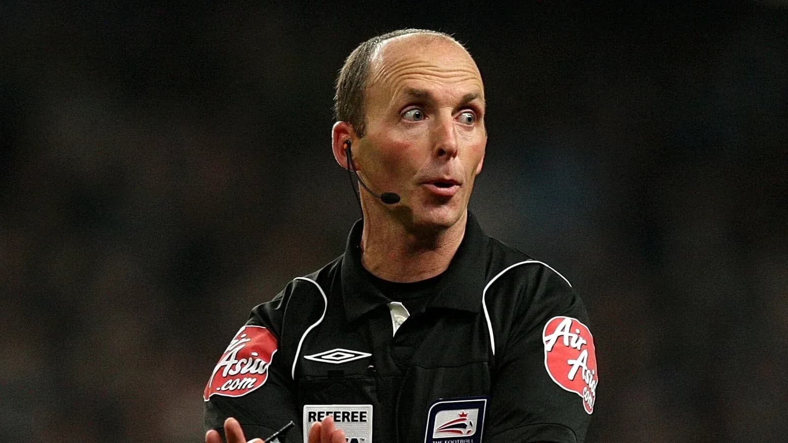 Referee signaling during a football match