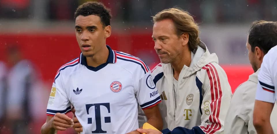 Bayern Munich player being guided by staff member