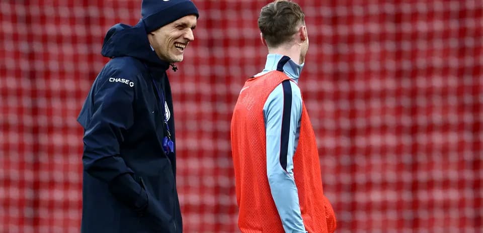Coach and player smiling during training session