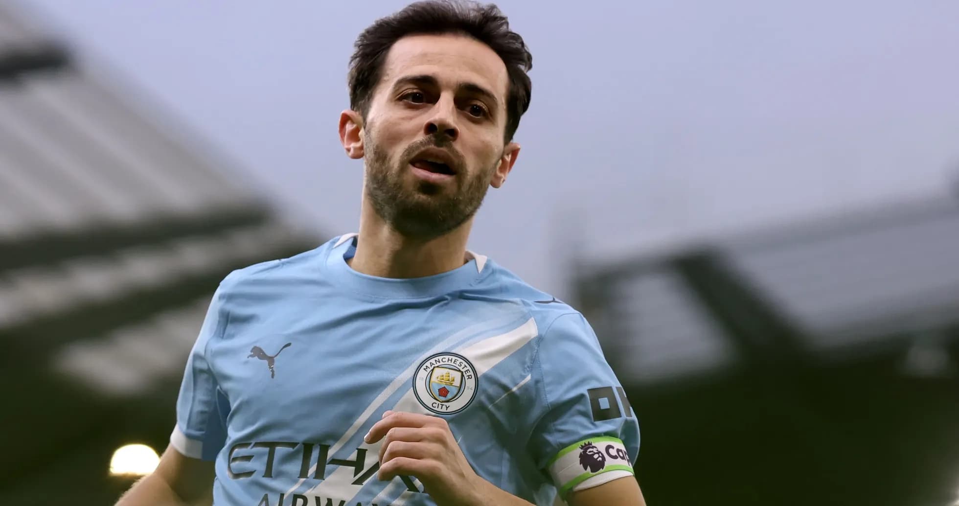 Player in Manchester City kit running on the pitch