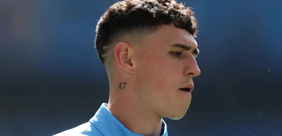 Player with short hair and neck tattoo during warm-up