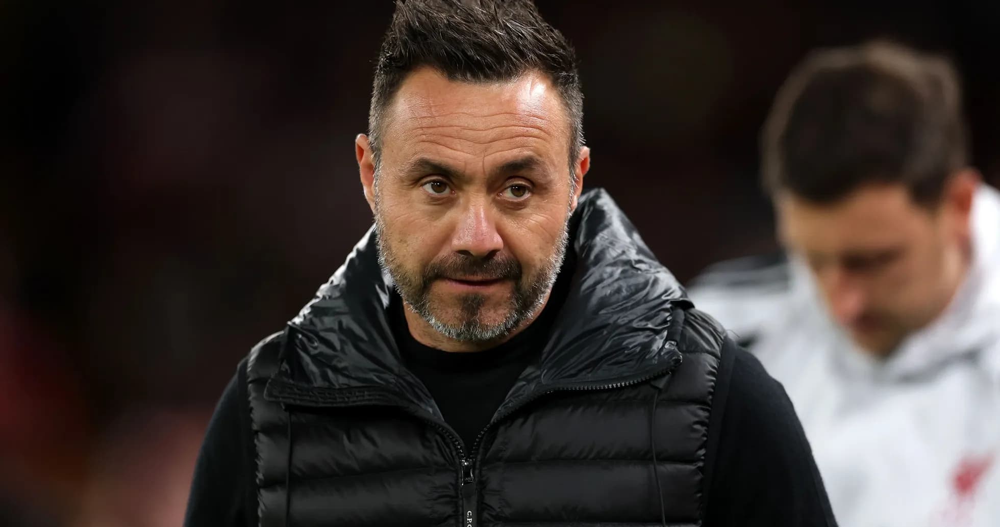 Coach in black vest during match preparations