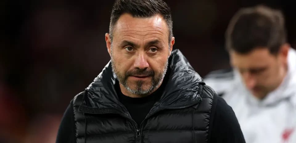 Coach in black vest during match preparations