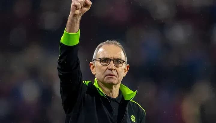 Manager raising fist in celebration on the pitch