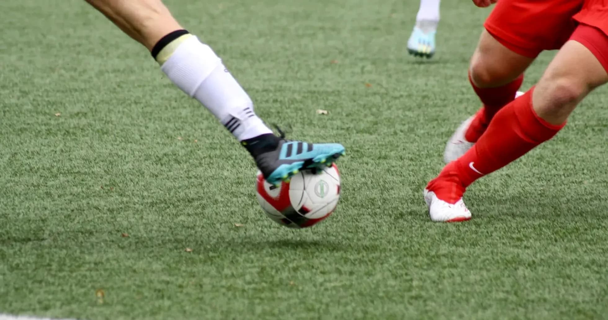 Two players contesting a football during match
