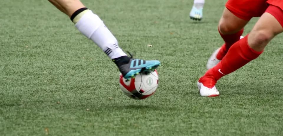Two players contesting a football during match