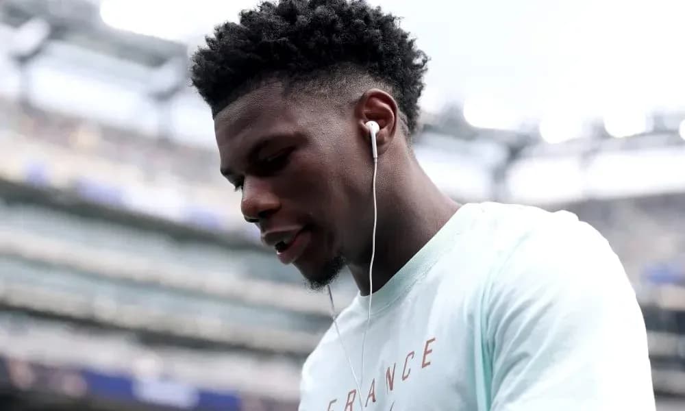 Player wearing earbuds on the field before match