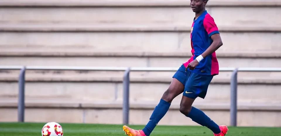 Player in Barcelona kit passing the ball on field