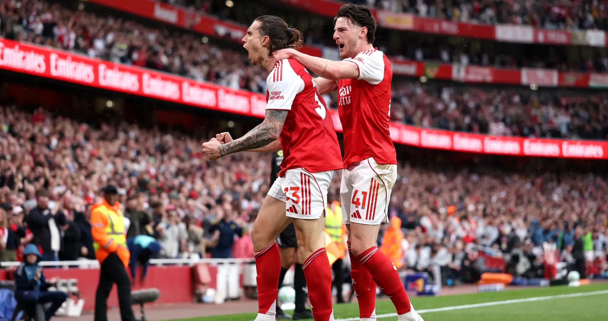 Two Arsenal players celebrating a goal on pitch