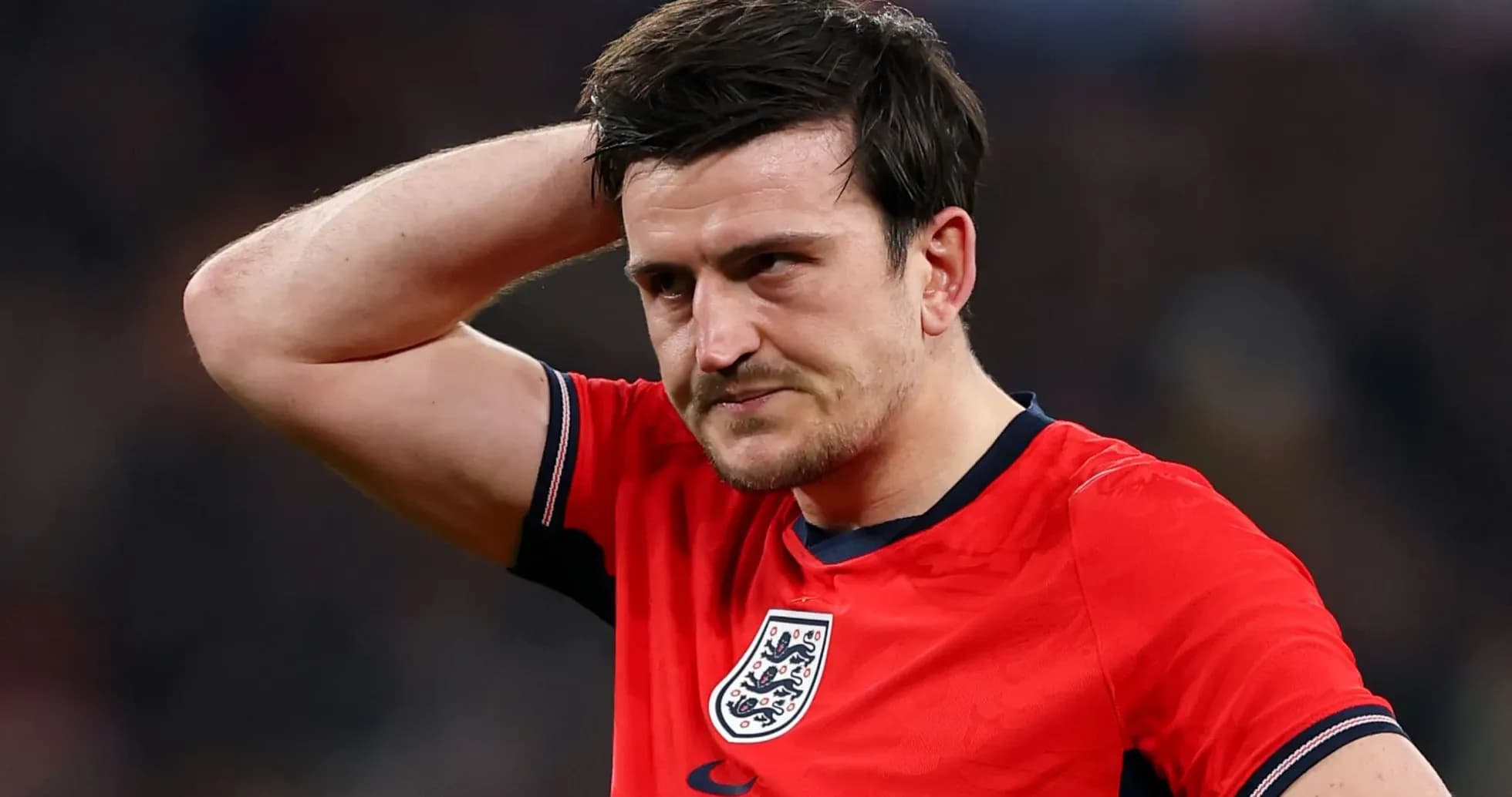 Player in red jersey looking frustrated during match