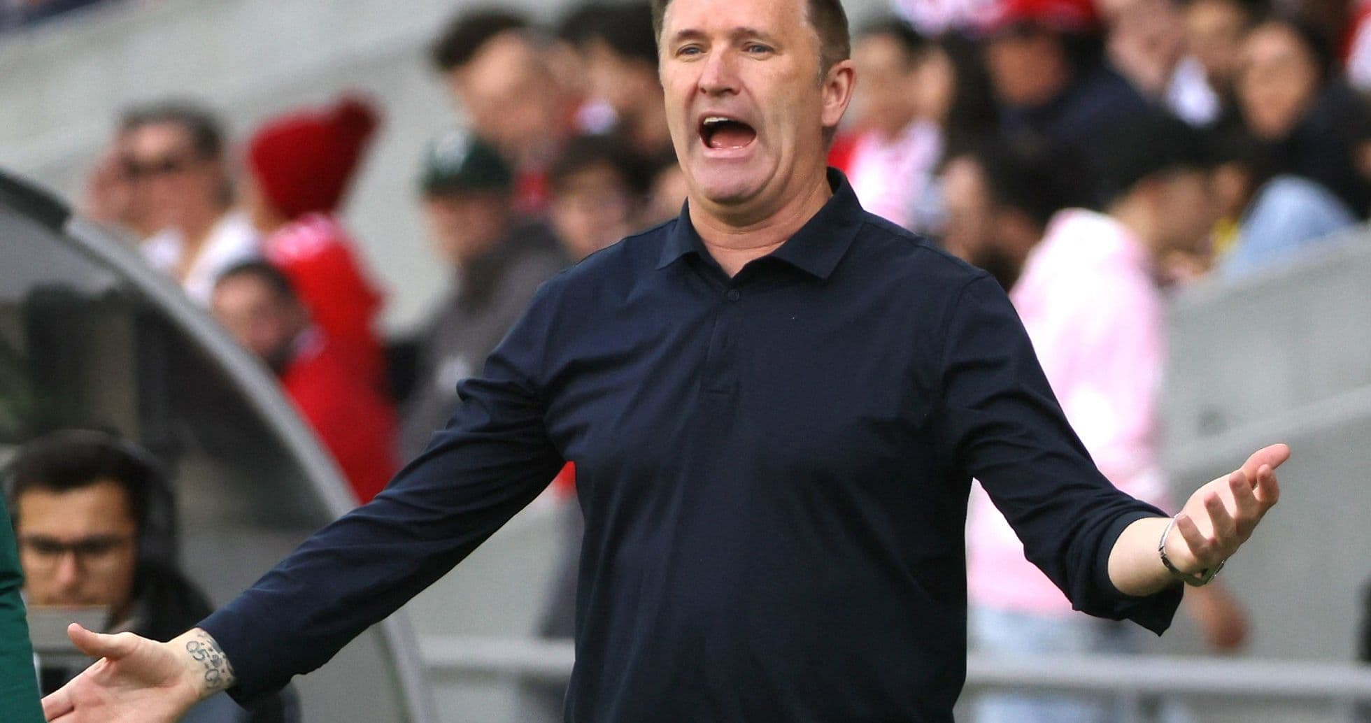Coach gesturing during match from sidelines